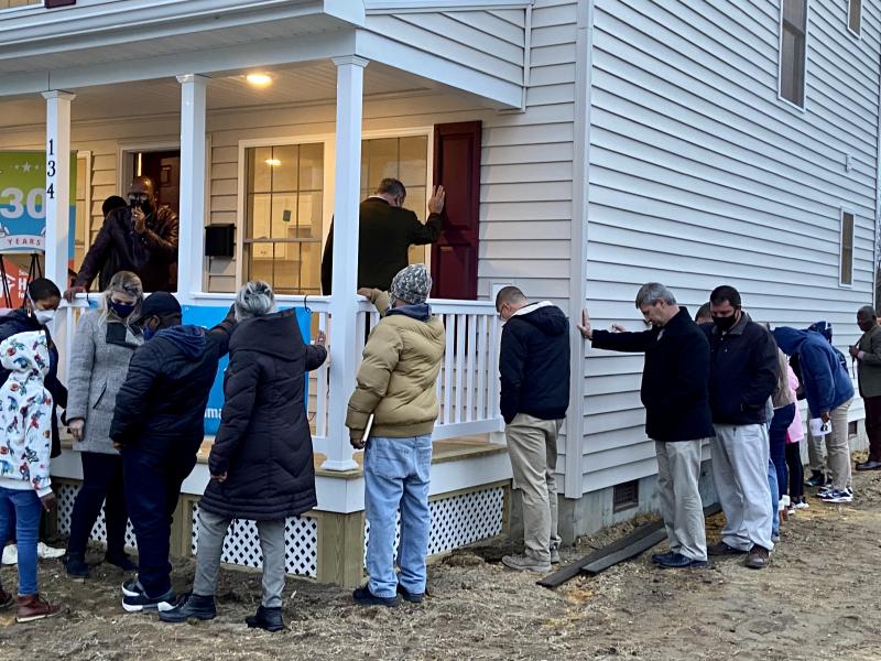As the sun sets, family, neighbors, Sussex County Habitat for Humanity staff and members of St. John’s United Methodist Men’s Group bless the new home and its owners. SUBMITTED PHOTOS